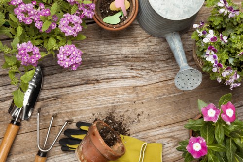 Gardeners applying health and safety measures during outdoor maintenance